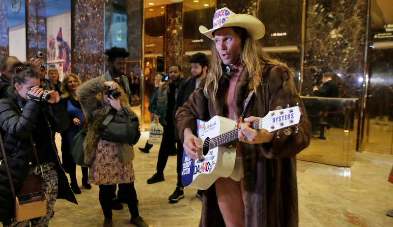 Here is the Naked Cowboy singing a Trump-themed song in the lobby of Trump Tower.